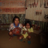 Maria and her granddaughter, in front of the board where each family in the community displays and sells their handcrafts. The jewelery is made from seeds and parts of rainforest plants, and the pottery from the red clay dirt that's characteristic of this area.