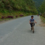 Along the way, I saw this kid on bike. Not just any bike.... this is an Ifugao wooden bike, and I wrote about these things in my Bonderman application essay. We pulled over in the tricycle so I could take a picture....