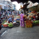Vinh Long street market. Notice the floral print matching pantsuit.... this was a major women's fashion trend in Vietnam. All different kinds of printed fabrics, made into the same style of matching top and pants.