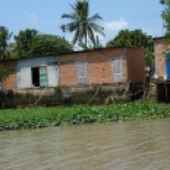 A house along one of the windy canals. Note the pipes carrying wastewater out to the river